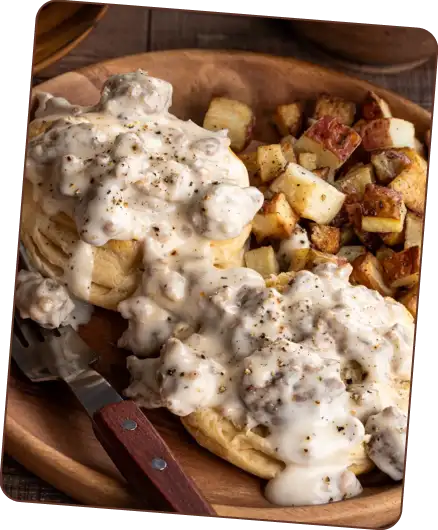 Biscuits with sausage gravy and potatoes.